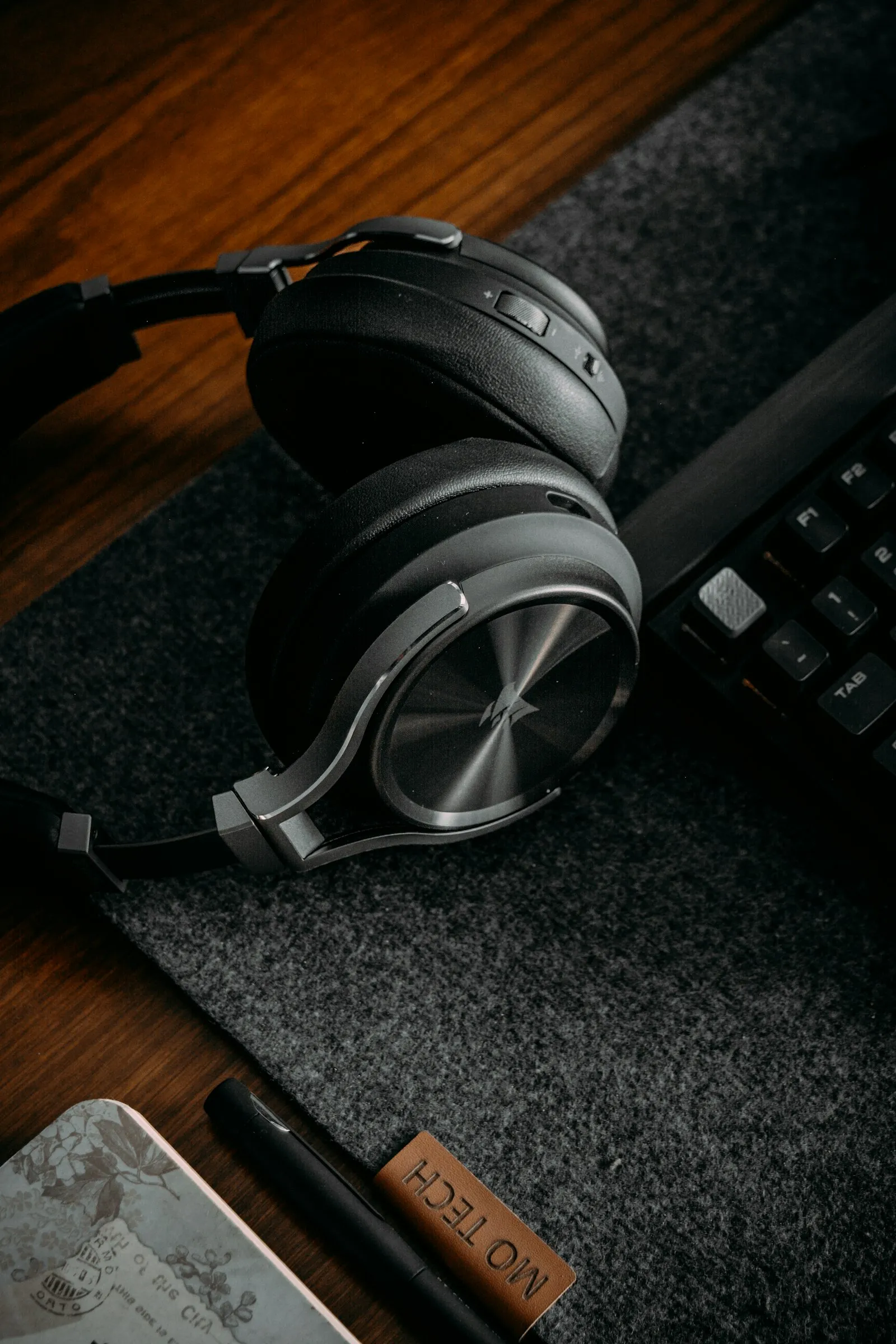 Over-ear headphones on a desk — the classic setup for personal sound amplification on iPhone